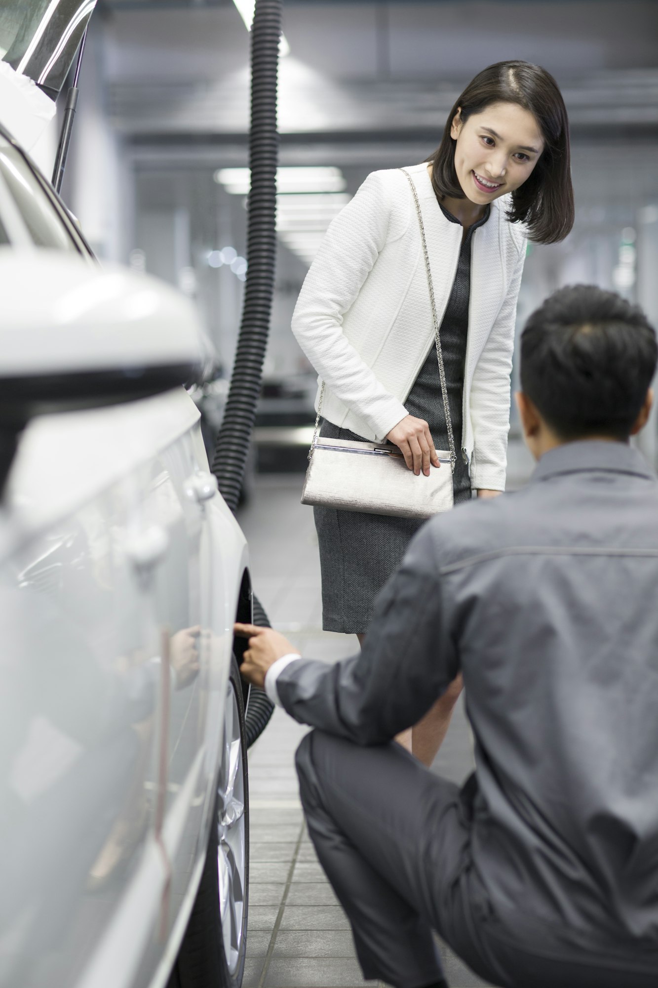 Auto mechanic talking with car owner